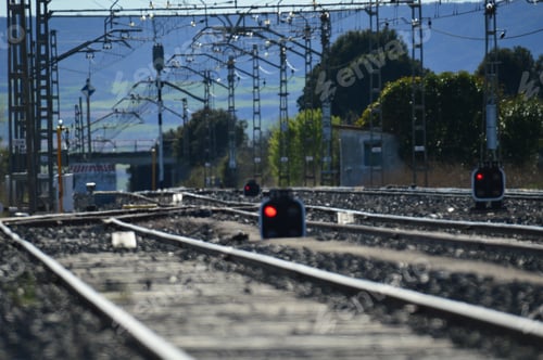 Preview: Selective focus shot of empty railroad tracks and semaphores with red lights
