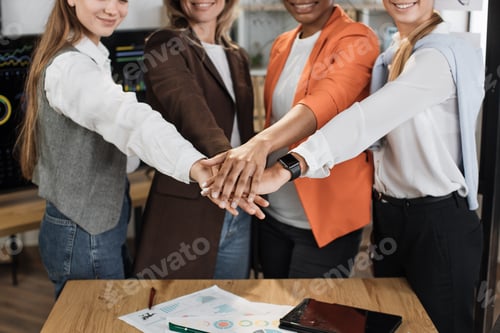 Preview: Close up of female stacking hands together after successful meeting at office room.