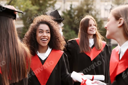 Preview: Group of happy students outdoors. Graduation ceremony