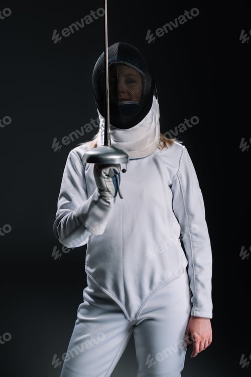 Preview: Fencer in fencing mask and suit holding rapier isolated on black