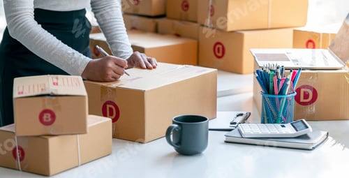 Preview: businesses SME owners entrepreneurs Writing the address on receipt box and check online orders