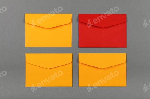 Preview: Four yellow and red paper envelopes over grey