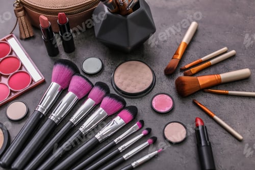 Preview: Makeup products and brushes on grey background