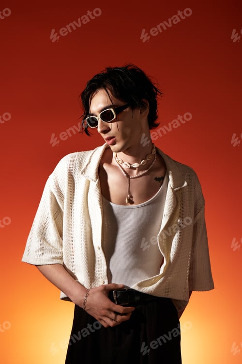 Preview: Slim young man showcases summer fashion in a vibrant studio setting
