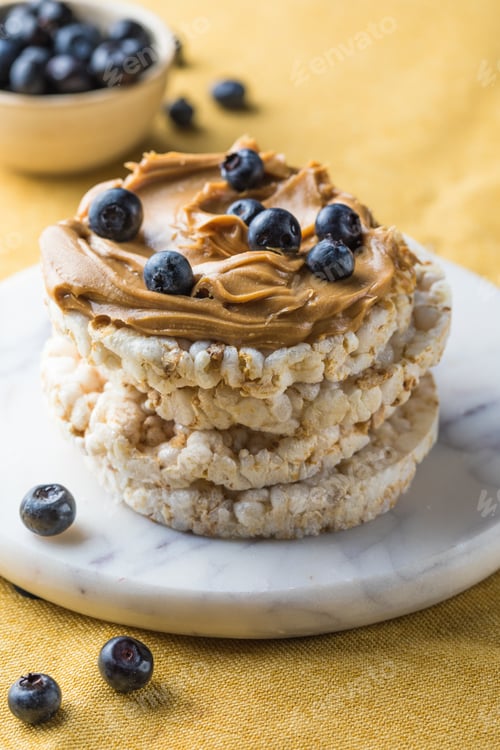 Preview: Peanut butter and rice cakes sandwich. Healthy protein snack.