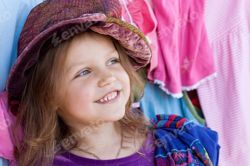 Preview: Happy Girl Among Colorful Clothes