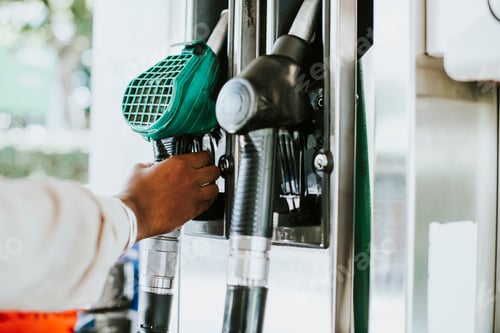 Preview: Man grabbing a fuel nozzle to refuel his vehicle