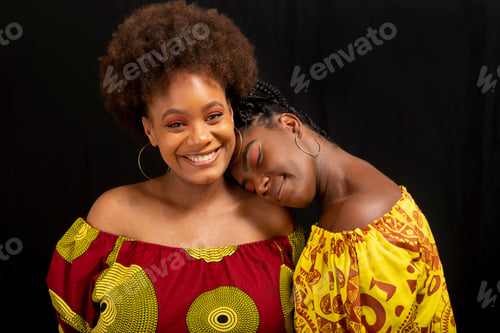 Preview: Portrait of two women against black background.