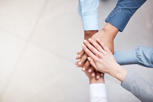 Vista previa: No holding back. Shot of a group of business people with their hands stacked.