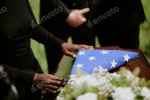 Preview: Young Adult Black Woman Mourning Beside Casket Holding Folded American Flag