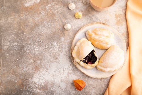 Preview: Glazed Pies with blueberry jam on brown concrete, top view, flat lay, copy space