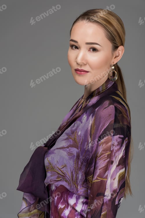 Preview: portrait of beautiful elegant kazakh woman looking at camera isolated on grey