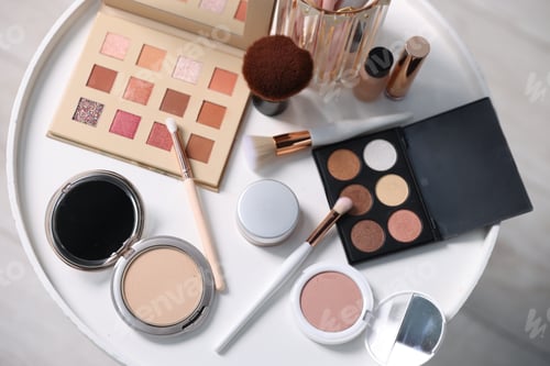 Preview: Different makeup products on white table indoors, flat lay