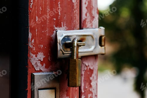 Preview: The old rusty padlock on the red door