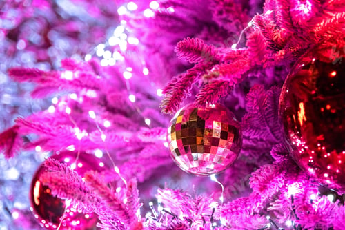 Preview: Magical winter new year background with ball on Christmas tree and lights