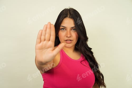 Preview: Woman making stop gesture expressing boundaries or refusal