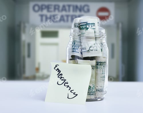 Preview: Shot of a note reading Emergency against a jar filled with money on a hospital counter