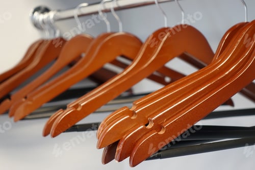 Preview: Close Up of Wooden Hangers on Rack