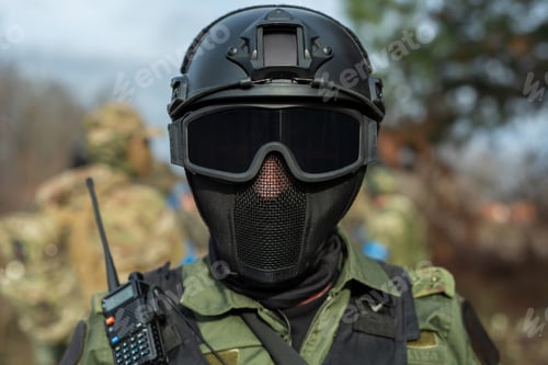 Preview: Portrait of a Special forces soldier in a helmet with a walkie-talkie.