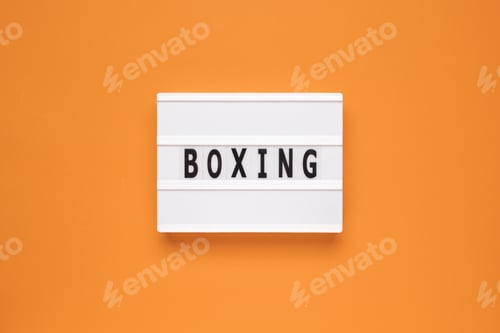 Preview: The word boxing on lightbox isolated orange background.
