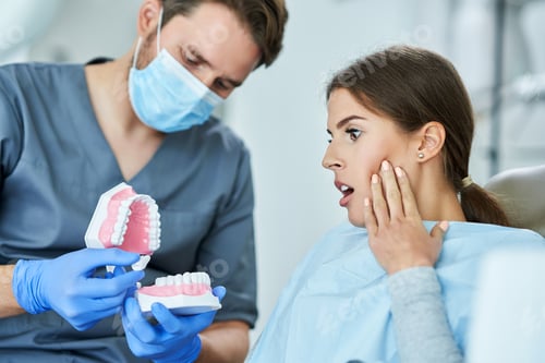 Preview: Male dentist and woman in dentist office