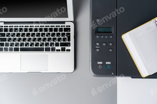 Preview: New modern printer and laptop in the office on table