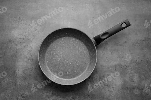 Preview: New non-stick frying pan on grey table, top view