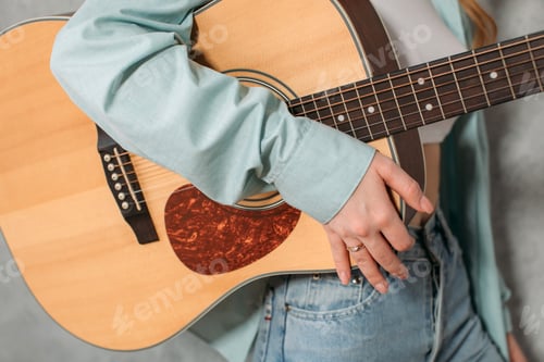 Preview: Acoustic guitar in a woman's hand