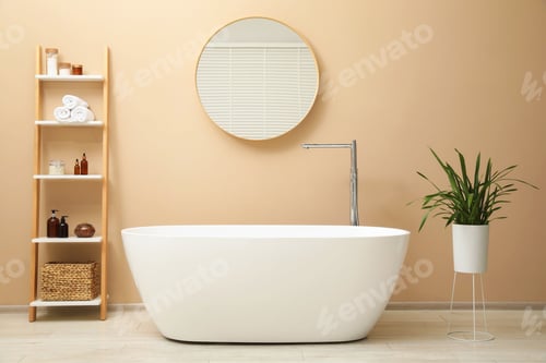Preview: Bathtub, houseplant, shelving unit and mirror in stylish bathroom