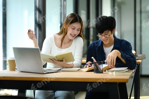 Preview: Cheerful female student explains her notes while working with classmate on their studies