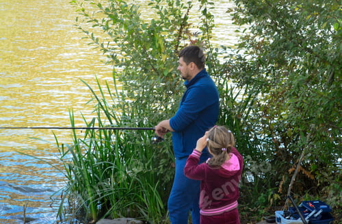 Preview: father teaches daughter to fish on a wild river