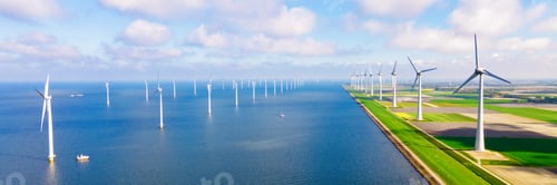 Preview: offshore windmill park with clouds and a blue sky