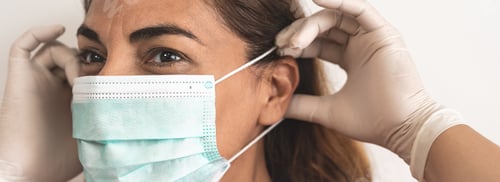 Preview: Mature Latin woman wearing face surgical mask and gloves
