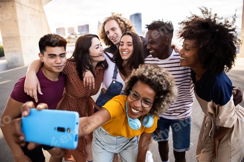 Preview: Group of happy young people taking selfie together on summer vacation