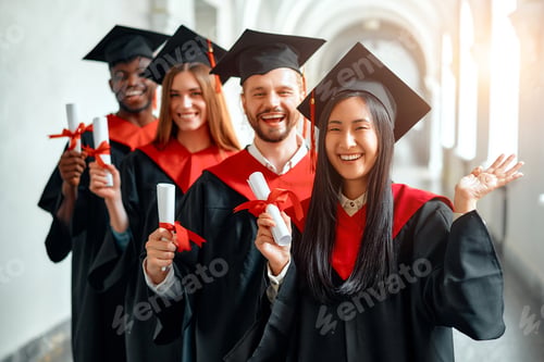 Preview: Graduates celebrating academic achievement with diplomas at university ceremony