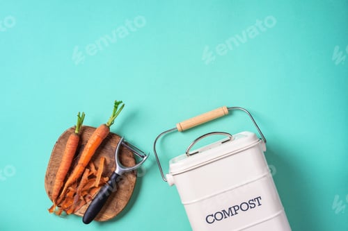 Preview: Top view of kitchen food waste collected in recycling compost pot. Peeled vegetables on chopping