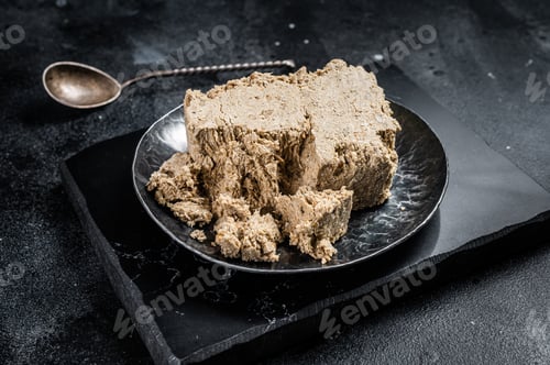 Preview: Homemade sunflower halva with honey. Black background. Top view