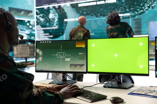 Preview: Serviceman operates on surveillance footage and green screen display
