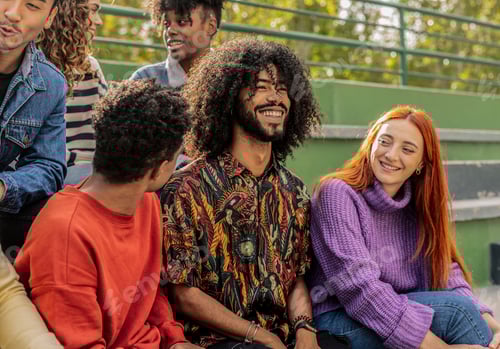 Preview: Group of people sitting and talking together outdoors