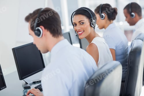 Preview: Smiling Call Centre Employee Looking Over Shoulder While Having A Discussion