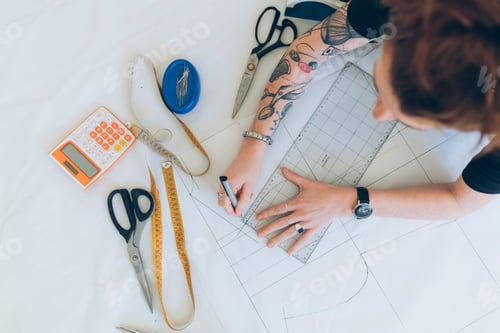 Preview: Fashion designer drawing and creating dressmaker's pattern