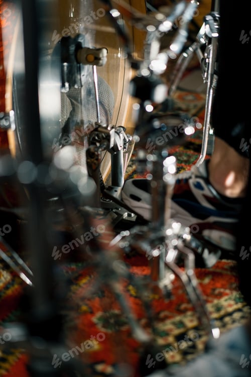 Preview: man's foot pressing bass drum pedal in recording studio drummer drumming indoors closeup