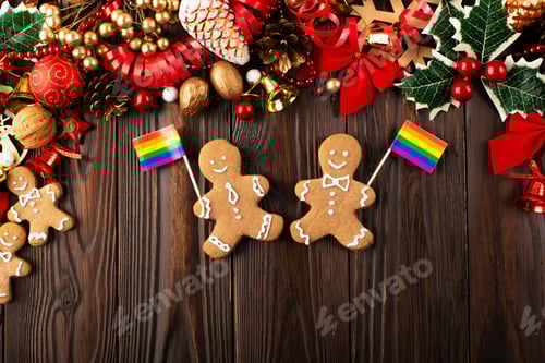Preview: Christmas background of gingerbread cookie men with rainbow flags on wooden table