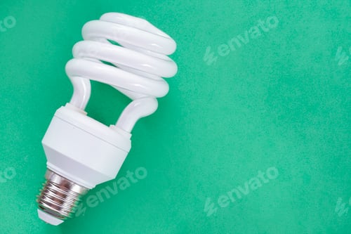 Preview: Fluorescent light bulb on green background, technology that contains polluting gases