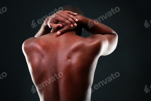 Preview: Back view portrait of a african man over black background