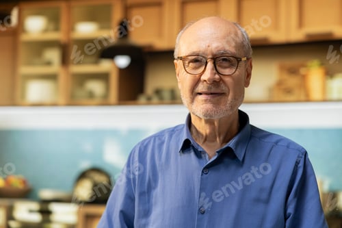 Preview: Portrait of aged pensioner standing in the kitchen with a gentle candid smile