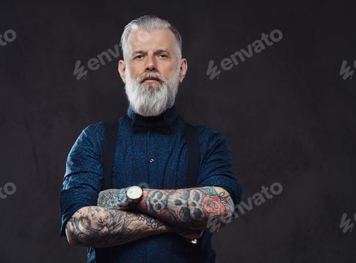 Preview: Caucasian grandfather poses in dark background with crossed arms