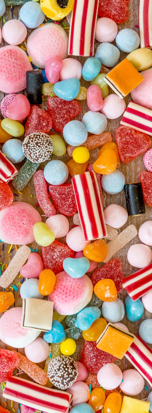 Preview: variety of candies on a wooden background