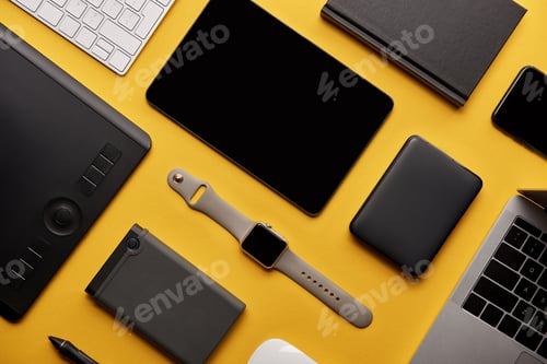 Preview: flat lay with different wireless devices on yellow surface