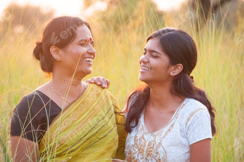 Preview: Portrait of happy mother and daughter in meadow at sunset. Smart Blurred photo